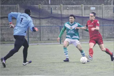  ?? Picture: Paul Amos FM4673787 ?? Canterbury’s Gary Mickelboro­ugh drives forward, prompting Ashford keeper George Kamurasi to rush out of his area