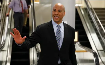  ??  ?? SENATOR CORY BOOKER waves to reporters earlier this month.