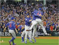  ?? THE ASSOCIATED PRESS ?? The Chicago Cubs celebrate after winning Game 7 of the World Series against the Cleveland Indians on Nov. 3 in Cleveland. The Cubs won 8-7 in 10 innings, and their first Series title since 1908 was voted the top AP sports story of 2016.