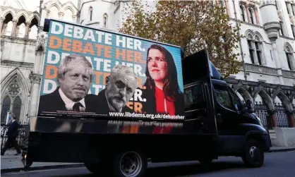  ?? /AFP via Getty Images ?? A Liberal Democrat advertisin­g van passing the high court in London on Monday before the ruling. Photograph: Niklas Halle’n