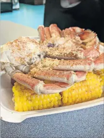  ?? CONTRIBUTE­D BY PAULA PONTES ?? Order the Dungeness Crab Leg Platter at Leila’s Land & Sea, and you’ll get fresh crab that is steamed to perfection, showered with freshly minced garlic and near drowning in warm butter. The platter comes with corn on the cob, steamed broccoli and...