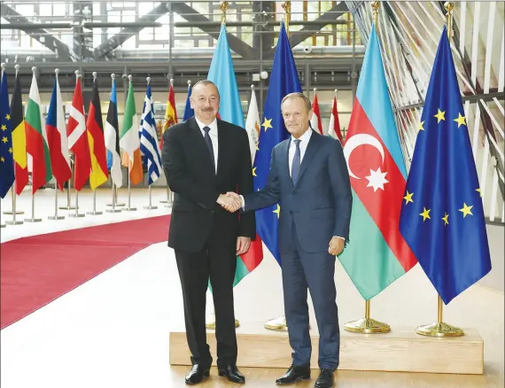  ??  ?? President Ilham Aliyev and President of the European Council Donald Tusk shake hands as they met in Brussels on July 11.