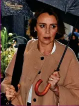  ?? ?? Sheltered from the rain: Keeley Hawes
Husband: Damian Lewis arriving yesterday