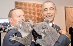  ??  ?? Abbott (left) and Obama each hold a koala before the G20 Leaders’ Summit in Brisbane handout photo by G20 Australia. — Reuters photo