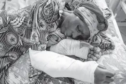  ?? AP MOSES SAWASAWA ?? A woman who was wounded in ongoing fighting between M-23 rebel forces and Congolese forces in the Sake region West of Goma, eastern Congo, lies on her hospital bed in Goma, yesterday.