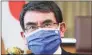  ?? Koji Sasahara / Associated Press ?? Japanese Vaccine Minister Taro Kono wearing a face mask with Japanese and EU flags said on Thursday even if the Olympics go on, there may be no fans of any kind in the venues. He said it’s probable the the Olympics will have to held in empty venues, particular­ly as cases surge across the country.