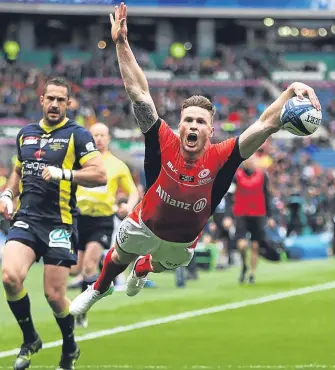  ??  ?? ■
Saracens’ Chris Ashton dives over to score the opening try at Murrayfiel­d yesterday.