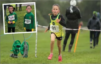  ??  ?? Ava Hand of Boyne AC drives hard through the rain to finish third in the Under-10 Girls race and (inset) Under-10 Boys runner-up Leyton Byrne with his brother Keilan Byrne after their event.