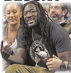  ?? STAFF FILE PHOTOS BY MATT STONE ?? New England Patriot LeGarrette Blount shows off his grill during the second half of the NBA game against the Cleveland Cavaliers.