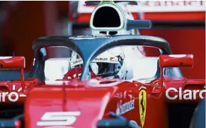  ?? — AFP ?? Halo goodbye: Ferrari’s Sebastian Vettel tests the so-called halo cockpit protection device during the 2016 pre-season testings in Barcelona on March 4.