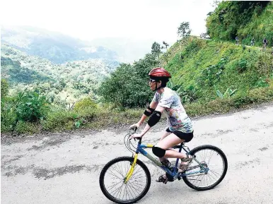  ?? PHOTO EDITOR RICARDO MAKYN MULTIMEDIA ?? A tourist taking a tour of the Blue and John Crow Mountains National Park on a mountain bicycle. The park is globally known for its biodiversi­ty and was inscribed on the UNESCO World Heritage List in July 2015.
