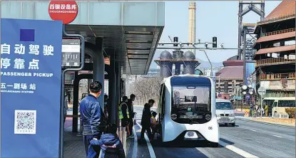  ?? LI WENMING / FOR CHINA DAILY ?? People board a driverless bus in Shougang Industrial Park, Beijing.