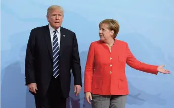  ??  ?? German Chancellor Angela Merkel welcomes U.S. President Donald Trump on July 7 before the opening of the G20 Summit in Hamburg, Germany