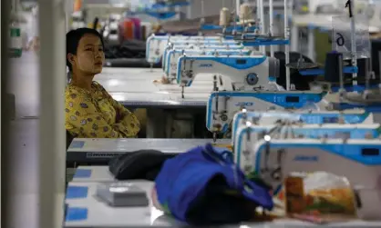  ??  ?? A woman sits near sewing machines as workers occupy a recently closed garment factory in Myanmar to demand their salaries. Photograph: Lynn Bo Bo/EPA