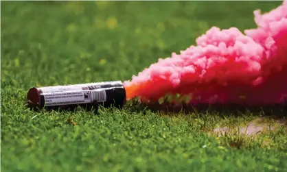  ?? Photograph: BSR Agency/Getty Images ?? A smoke bomb thrown on the pitch by West Ham supporters during their 2-2 draw in Genk.