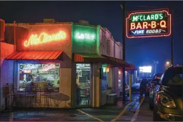  ?? The Sentinel-Record/Grace Brown ?? ICONIC SPOT: McClard’s Bar-B-Q is awash in the glow of neon signs on Jan. 15.