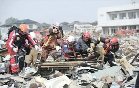  ??  ?? SOUTH African rescue team members in the aftermath of the earthquake disaster that hit eastern Japan in 2011. It was the first rescue mission from Africa to Japan.