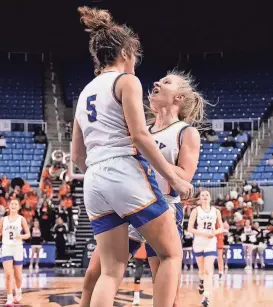  ?? ?? Savannah Stoker and Britain Backus celebrate Thursday night after winning state basketball.