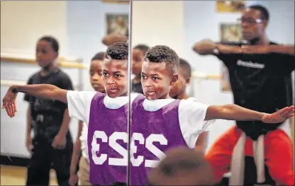  ?? PHOTOS BY JIM WEBER/THE COMMERCIAL APPEAL ?? Dunbar Elementary student Marshunn Wright, 10, concentrat­es on his dance moves as Shamar Rooks (right) with New Ballet Ensemble teaches his Boys Hip Hop class a new routine. The ensemble has partnered with the Orange Mound school for six years,...