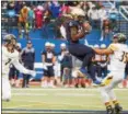  ?? BARRY BOOHER — THE NEWS-HERALD ?? John Carroll’s William Woods makes a catch between Wisconsin-Oshkosh defenders on Sept. 2 at John Carroll.