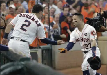  ?? DAVID J. PHILLIP — THE ASSOCIATED PRESS ?? The Astros’ Jose Altuve celebrates his solo home run, his third of the game, against the Red Sox with teammate Alex Bregman in the seventh inning in Game 1 of baseball’s American League Division Series on Oct. 5 in Houston.