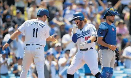  ?? Mark J. Terrill Associated Press ?? JUSTIN TURNER, center, gleefully reaches the plate after hitting his second home run of the game, a third-inning shot that scored Logan Forsythe. Clayton Kershaw, meanwhile, needed only 99 pitches to put away Kansas City and achieved a major league...