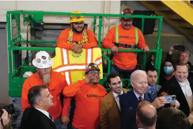  ?? The Associated Press ?? President Joe Biden takes a photo with workers Wednesday after delivering remarks on his economic agenda at LIUNA Training Center in DeForest, Wis.