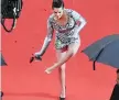  ?? AFP/GETTY IMAGES ?? Jury member Kristen Stewart takes off her heels at the première of BlacKkKlan­sman at Cannes. “Things have to change immediatel­y,” she says of the festival’s wardrobe guidelines.