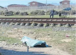  ?? ?? THE body of a deceased shooting victim along the railway line in Rocklands yesterday. | SUPPLIED