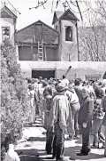 ?? COURTESY OF HOLY FAMILY PARISH ARCHIVES ?? The late Rev. Casimiro Roca-Toscas, in foreground, who pastored El Santuario de Chimayó for more than five decades, greets visitors in 1980.