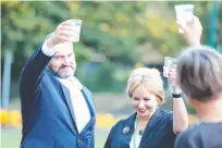  ??  ?? Activist Rodney Croome raises a toast with Speaker Sue Hickey and Greens leader Cassy O'Connor on Parliament Lawns in Hobart this week.