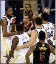  ?? BEN MARGOT — THE ASSOCIATED PRESS ?? Cavaliers center Tristan Thompson, top, yells at Warriors forward Draymond Green, bottom, during overtime of Game 1of the NBA Finals in Oakland Thursday. The Warriors won 124- 114.