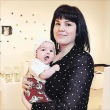  ?? PHOTOS: CHERYL CLOCK THE ST. CATHARINES STANDARD ?? Mother, artist and Brock visual arts student Amber Lee Williams is pictured in the Marilyn I. Walker gallery with her two-month-old daughter, Octavia.