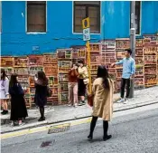  ??  ?? A woman standing on the road taking pictures of her friends at a popular Instagram spot in Hong Kong.