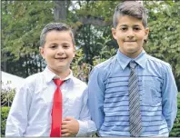  ?? KATIE SMITH/THE GUARDIAN ?? Robbie Kaboush, 7, and his brother Rami, 9, of Charlottet­own attended a citizenshi­p ceremony Friday at Ardgowan National Historic Site to show support to their aunt and cousins who became Canadian citizens.