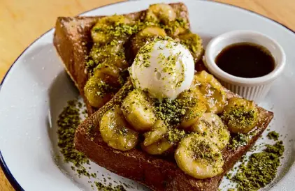  ?? ?? The pistachio French toast boasts caramelize­d banana and an ice cream scoop of kaymak.
