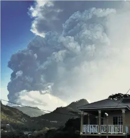  ?? ORVIL SAMUEL AP ?? Ash rises into the air as La Soufriere volcano erupts on the eastern Caribbean island of St. Vincent.