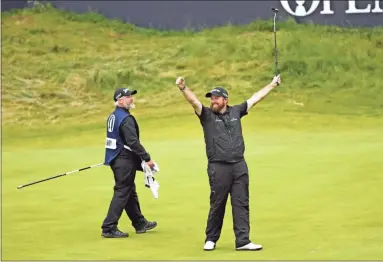  ?? Ap-peter Morrison ?? Ireland’s Shane Lowry lifts his club to celebrate as he wins the British Open Golf Championsh­ips at Royal Portrush in Northern Ireland on Sunday.