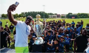  ?? — supplied photo ?? Dwayne Bravo takes a selfie with the kids at the ICC Academy in Dubai on Sunday.