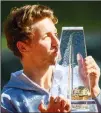  ??  ?? Casper Ruud of Norway kisses the trophy after beating Denis Shapovalov of Canada during their final men’s match, at the ATP 250 Geneva Open tournament in Geneva, Switzerlan­d, on May 22. (AP)