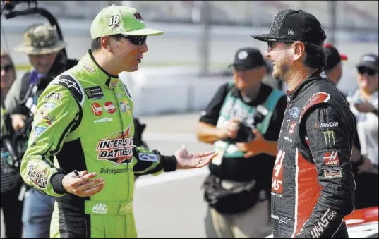  ?? Paul Sancya The Associated Press ?? Las Vegas native Kyle Busch, left, talks with his brother Kurt Busch before qualifying Friday for the NASCAR Cup Series Consumers Energy 400 on Sunday at Michigan Internatio­nal Speedway in Brooklyn, Mich. Kyle Busch is tied with Kevin Harvick for most Cup wins this season with six.