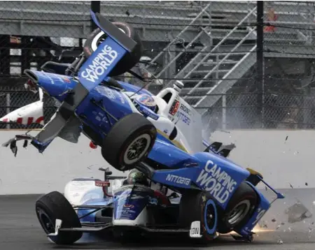  ?? MARTY SEPPALA/THE ASSOCIATED PRESS ?? Pole sitter Scott Dixon, top, and Jay Howard came away uninjured after a crash at Turn 1 where Dixon’s car struck Howard’s and went airborne.