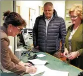  ?? PHOTO COURTESY OF KATHLEEN SANVIDGE ?? Kathleen Sanvidge, Licensed Funeral Director and owner of Townley & Wheeler, signing her grant agreement with Town Supervisor Tim Szczepania­k and Deputy Town Clerk Jodi Hollowood witnessing.