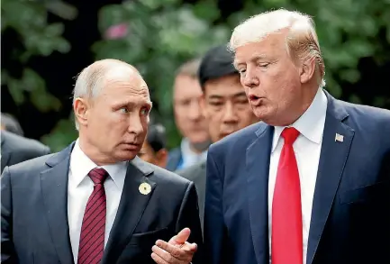  ?? PHOTO: REUTERS ?? US President Donald Trump and Russia’s President Vladimir Putin talk during the family photo session at the Apec summit in Danang, Vietnam.