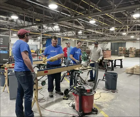  ?? PHOTOS PROVIDED ?? National Grid employees volunteer to build beds.