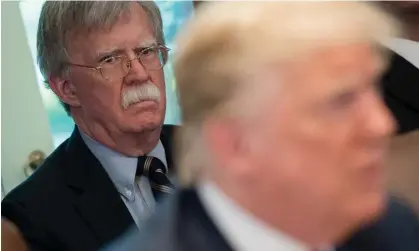  ?? Photograph: Saul Loeb/AFP/Getty Images ?? John Bolton listens as Donald Trump speaks during a cabinet meeting in 2018.