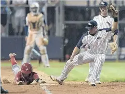  ?? MICHAEL LAUGHLIN/STAFF PHOTOGRAPH­ER ?? North Broward Prep’s Gabriel Esquivel, left, gets to first base before Monsignor Pace’s MC Sagaro during their regional final on Tuesday night in Coconut Creek.