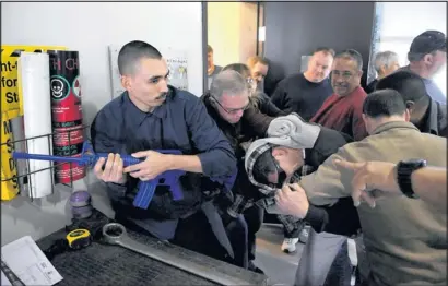  ?? PAT VASQUEZ-CUNNINGHAM/JOURNAL ?? Gardner Zemke employee Jesus Dominguez, left, disarms the shooter as he is swarmed by other employees during a training exercise conducted by Global One last week.