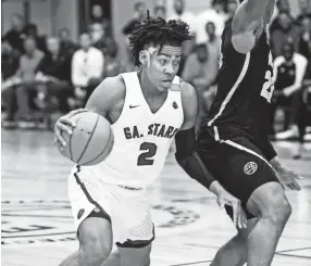  ?? MARK ?? Georgia Stars guard Trendon Watford (left) drives by Athletes Of Tomorrow defender Isaac Okoro (right) during their Nike EYBL game in Dallas, Texas. WEBER/THE COMMERCIAL APPEAL