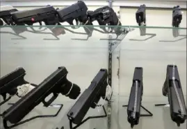  ?? Associated Press ?? Guns on display at a gun store in Miami.